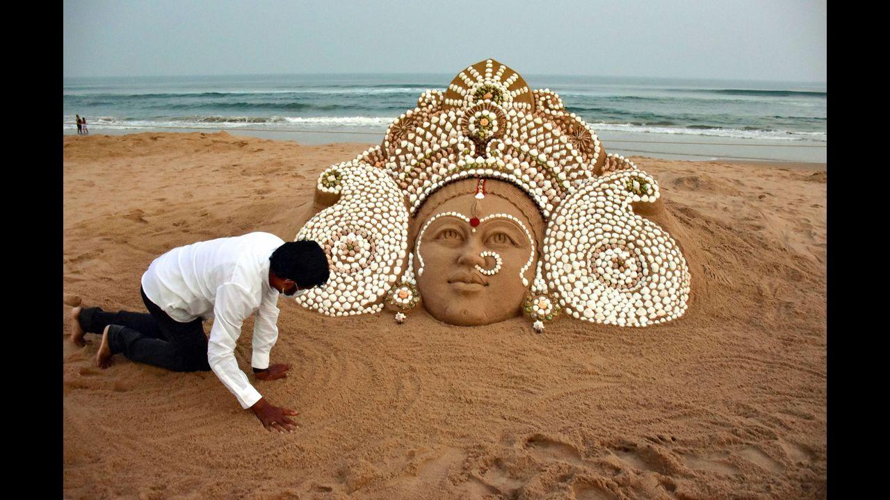 Padma Shri awardee artist Sudarshan Pattnaik creates a sand art of Goddess Durga during the ongoing Durga Puja festival, at Puri beach. Pic/PTI
